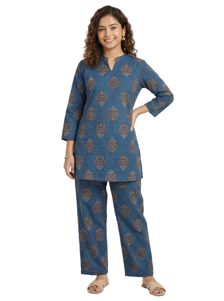 Woman wearing a blue patterned kurta with matching pants on a white background
